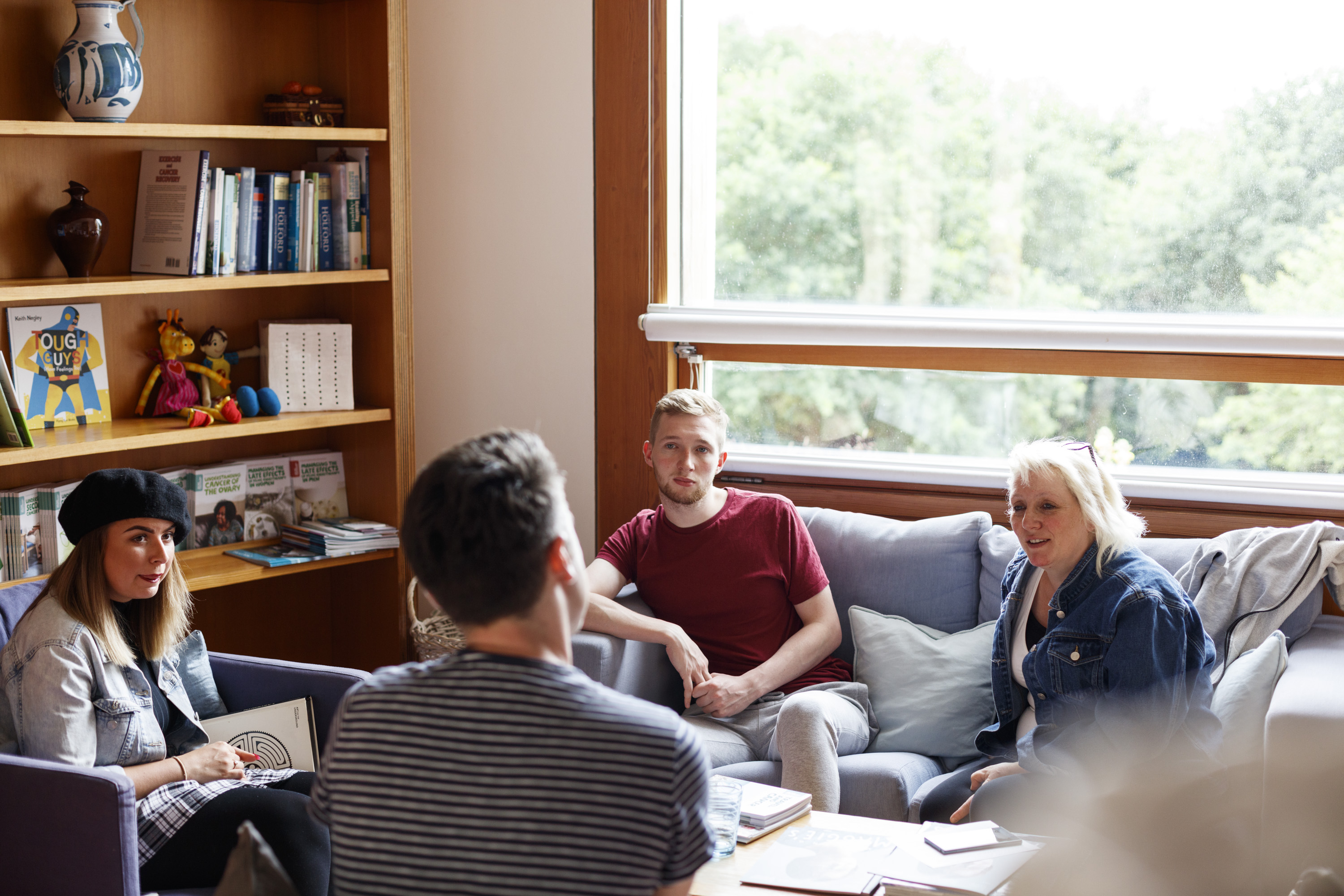 Support group sitting on sofas