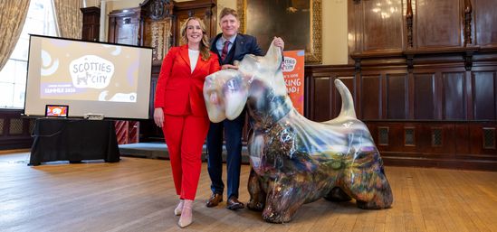 Scottie in the city dog Lochie with artist and Maggie's representative