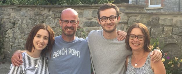 Sarah and her family standing arm in arm