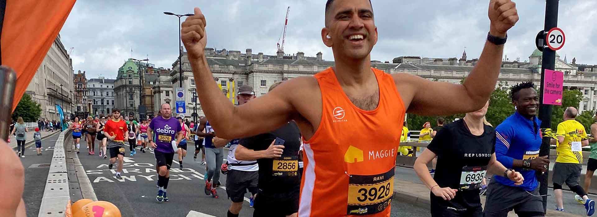 Maggie's runner smiling with a thumbs up post at London Landmarks