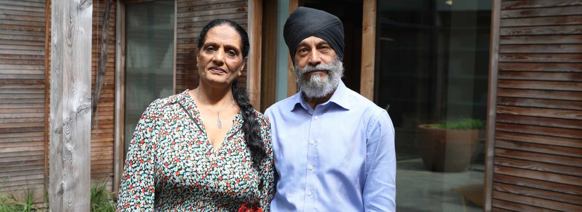 Kirpal and partner standing outside our West London centre