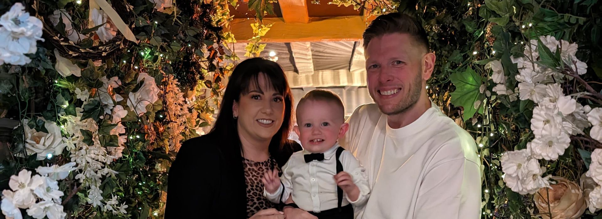 Anthony with partner and young son smiling