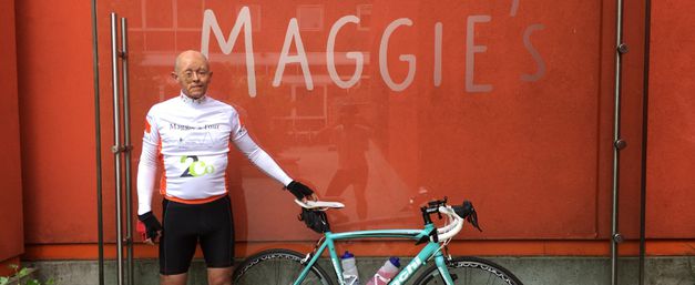 Graeme, standing in front of Maggie's, West London, wearing cycling kit and holding bike