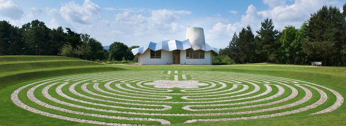 Wide-angled landscape showing Maggie's in Dundee and the garden