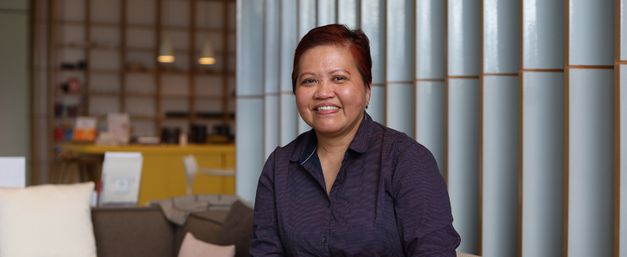 Portrait of Nancy, smiling, in Maggie's centre
