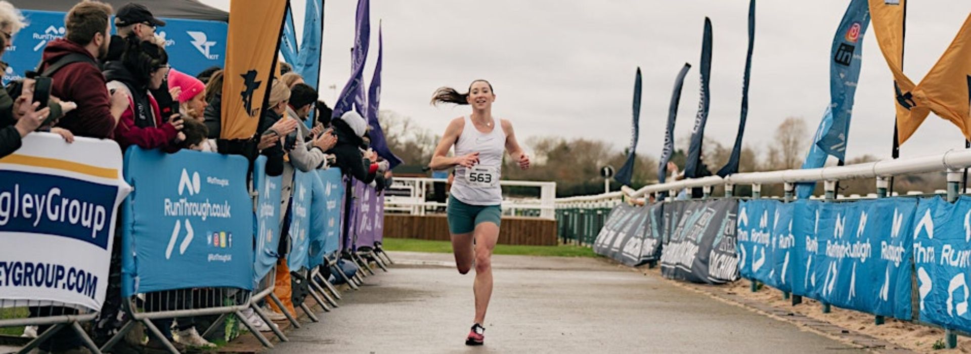 Female runner coming into the finish funnel