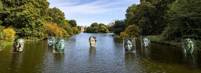 Landscape of art installation of portraits of National Lottery 'game changers' on St James's Park Lake, London