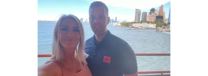 Cara and partner smiling whilst on a boat