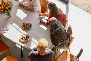 Women gathered around the kitchen table at Maggie's Royal Marsden