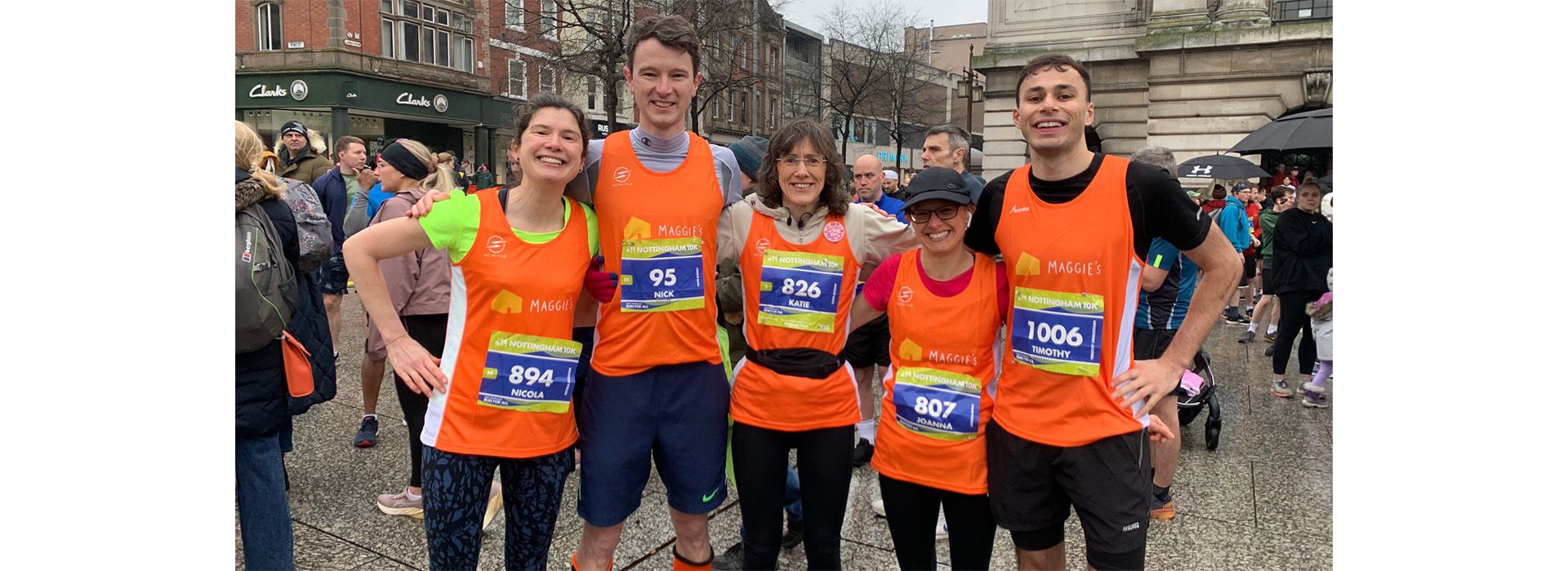 Five runners, arm in arm, wearing Maggie's vests at the finish of the Nottingham 10K