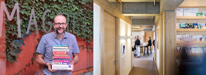 Maggie's representative holds books about cancer outside West London centre